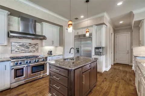 a kitchen with a stove and a refrigerator