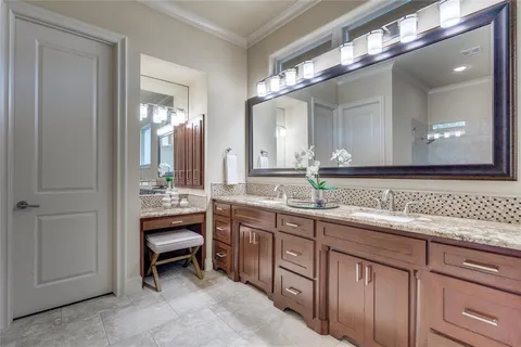 a spacious bathroom with a double vanity sink and a mirror
