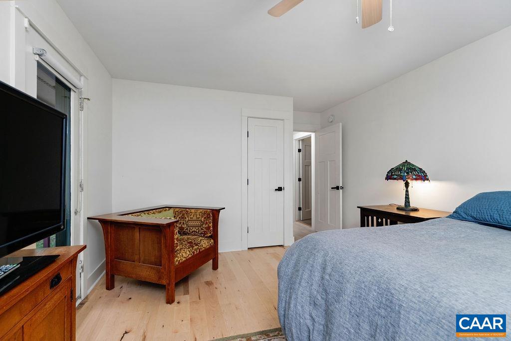 18 Grassy Overlook Wintergreen, VA 22967 - Photo 28 of 65 a bedroom with a bed and a flat tv screen on a dresser