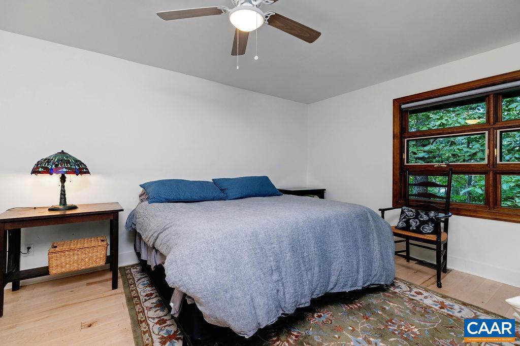18 Grassy Overlook Wintergreen, VA 22967 - Photo 29 of 65 a bedroom with a bed and a chandelier