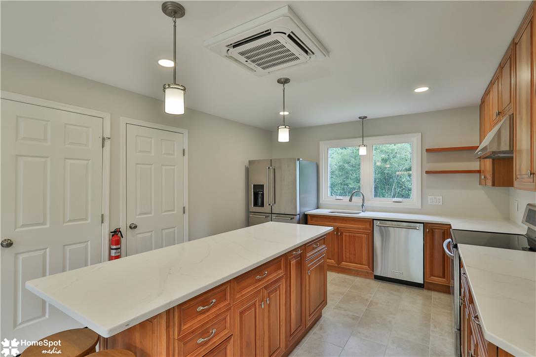 919 Point Phillips Road Bath, PA 18014 - Photo 12 of 59 A well-appointed kitchen offers an inviting island, ample cabinetry, and sleek stainless steel appliances.