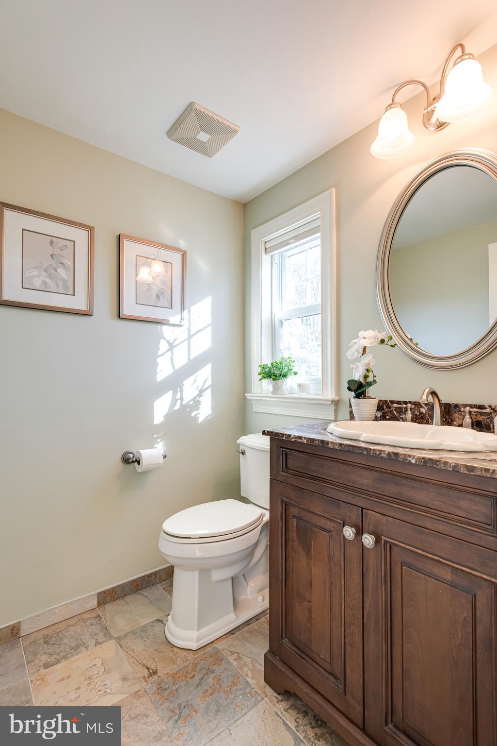 1040 Great Springs Road Bryn Mawr, PA 19010 - Photo 27 of 50 a bathroom with a toilet a sink and a mirror