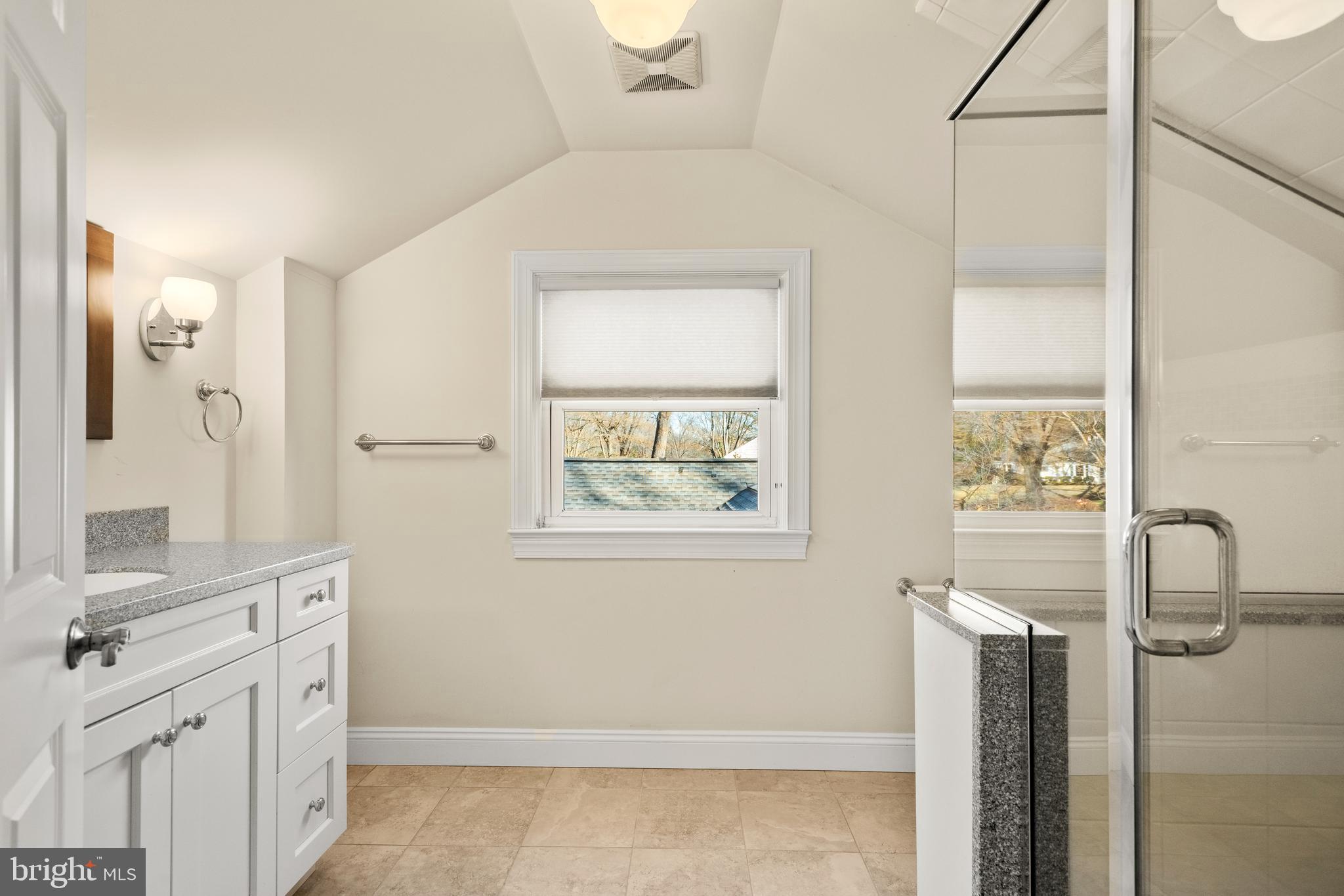 1040 Great Springs Road Bryn Mawr, PA 19010 - Photo 30 of 50 a bathroom with a double vanity sink a mirror and a shower
