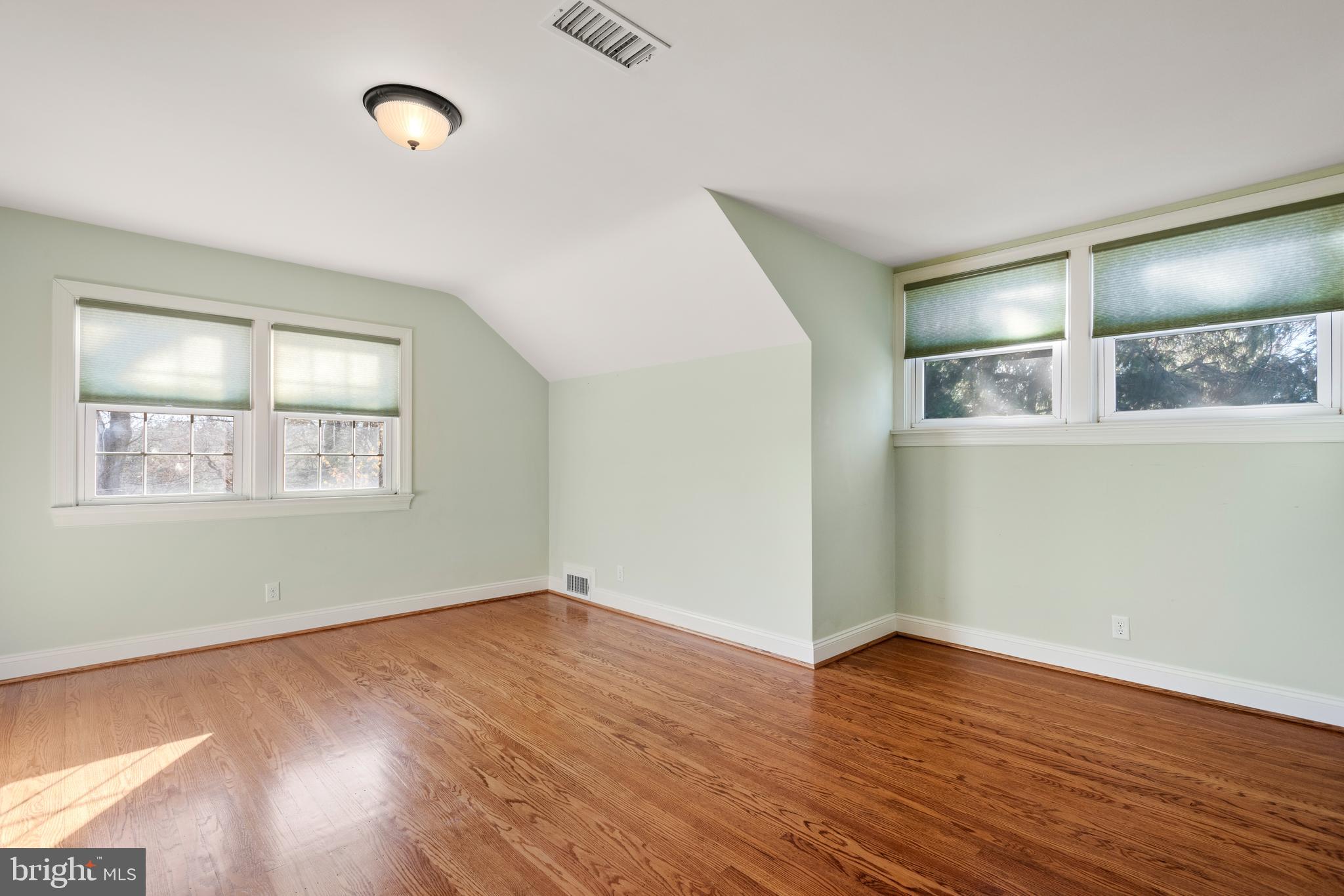 1040 Great Springs Road Bryn Mawr, PA 19010 - Photo 31 of 50 an empty room with wooden floor and windows