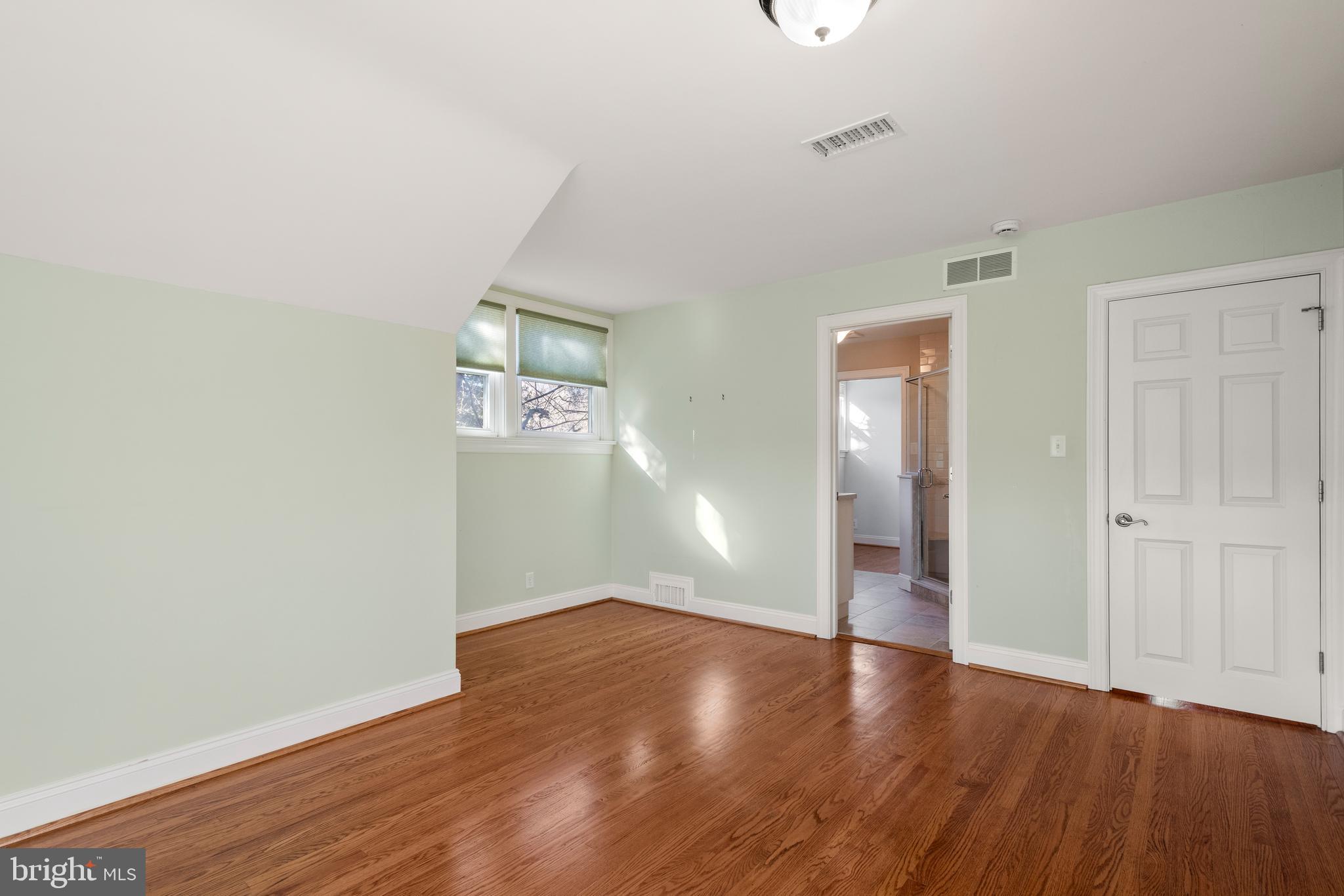 1040 Great Springs Road Bryn Mawr, PA 19010 - Photo 32 of 50 an empty room with wooden floor and windows