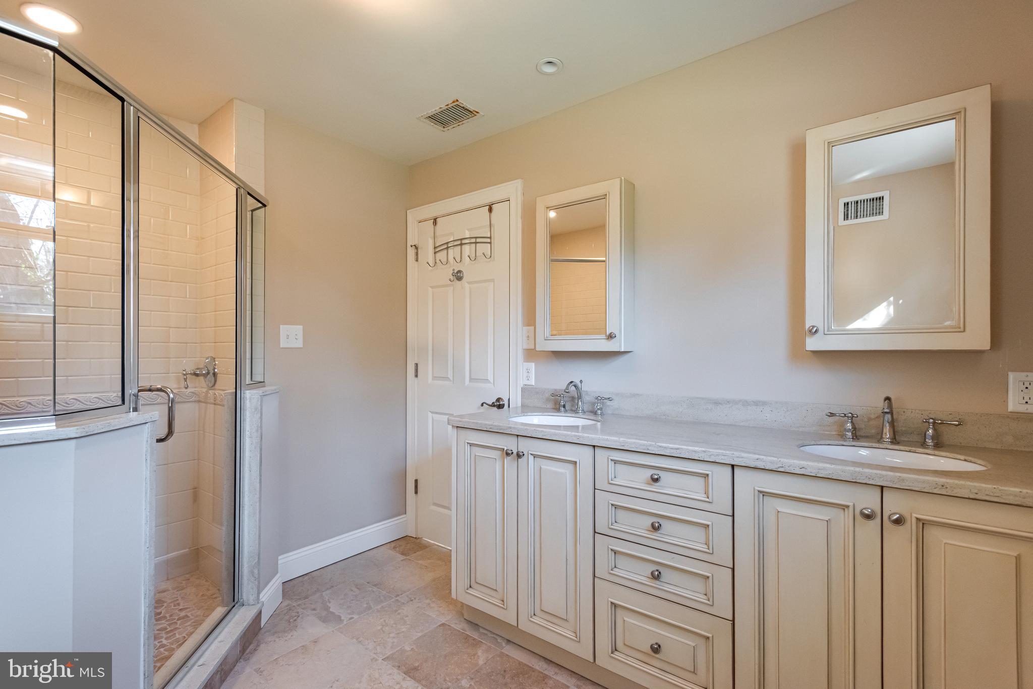 1040 Great Springs Road Bryn Mawr, PA 19010 - Photo 34 of 50 a bathroom with a double vanity sink and mirror