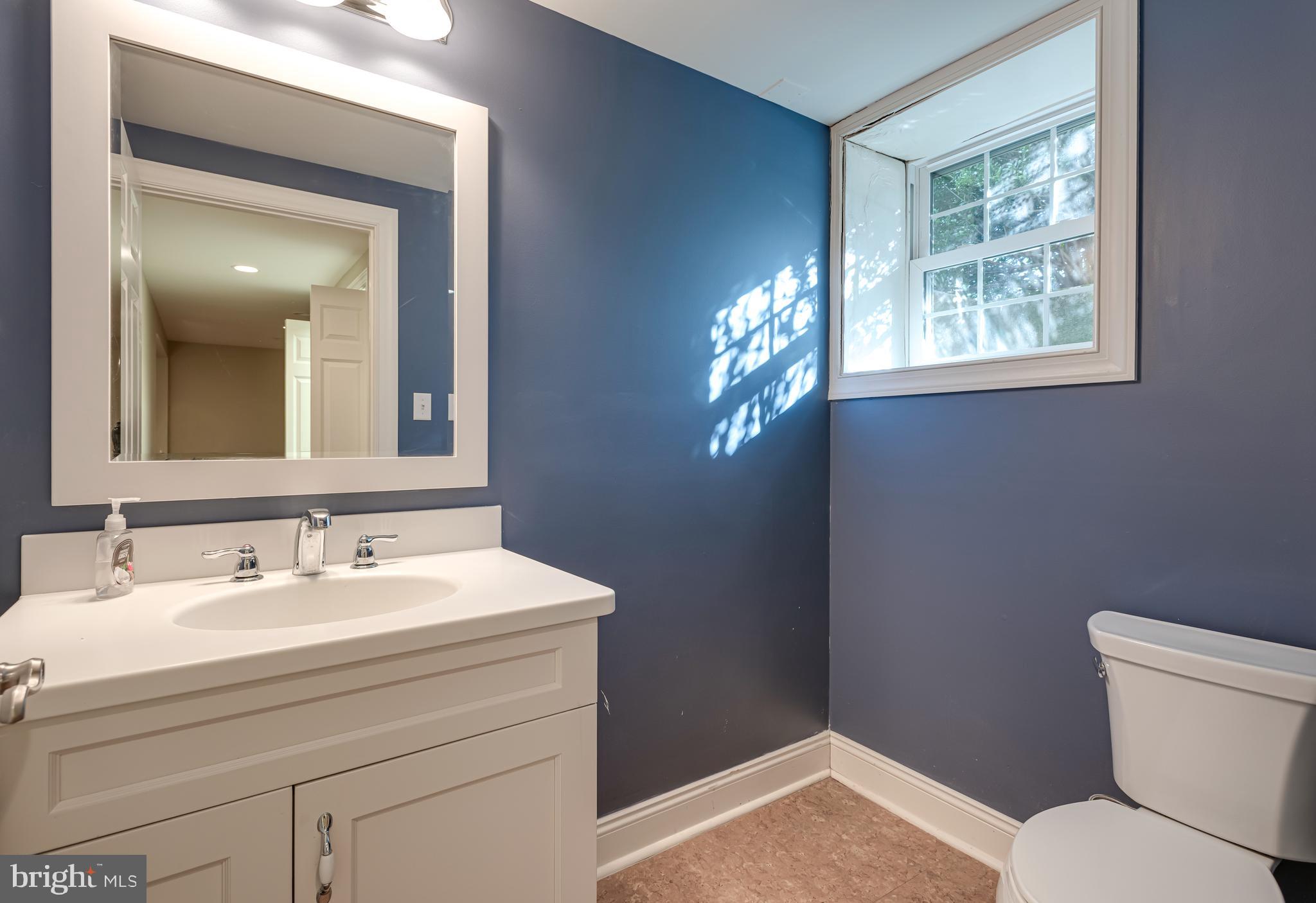 1040 Great Springs Road Bryn Mawr, PA 19010 - Photo 40 of 50 a bathroom with a toilet sink vanity and mirror