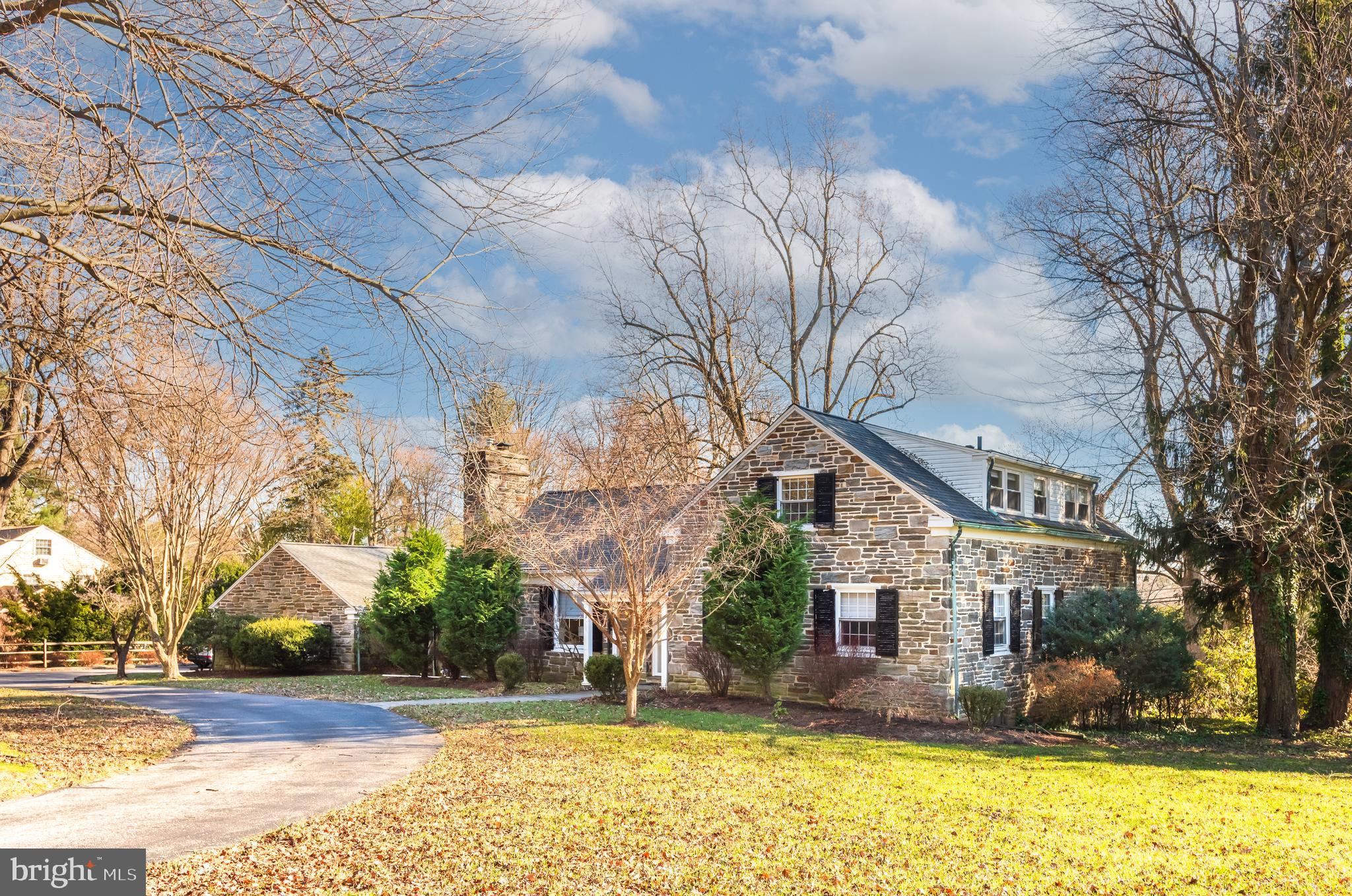 1040 Great Springs Road Bryn Mawr, PA 19010 - Photo 4 of 50 a view of a house with a yard covered with snow and trees