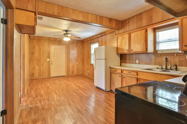 a view of a kitchen with a sink and a refrigerator