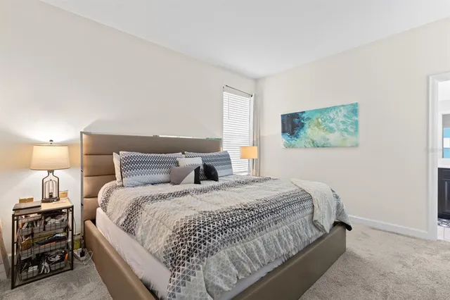 a bedroom with a bed and a lamp