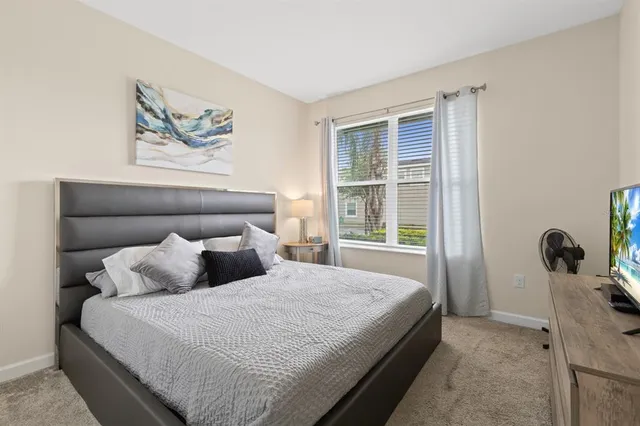 a bedroom with a bed and a window