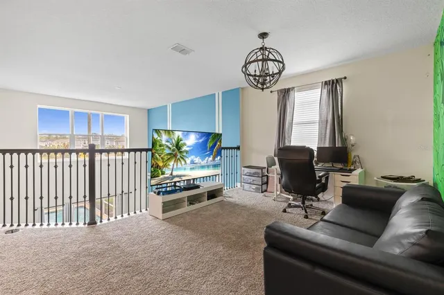 a livingroom with workspace and a couch