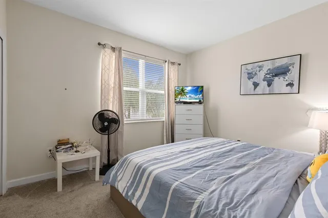 a bedroom with a bed and a window