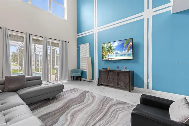 a bedroom with furniture and a flat screen tv