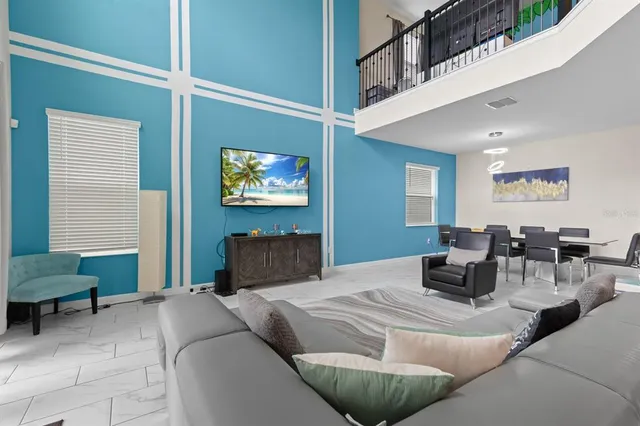 a bedroom with furniture and a large window