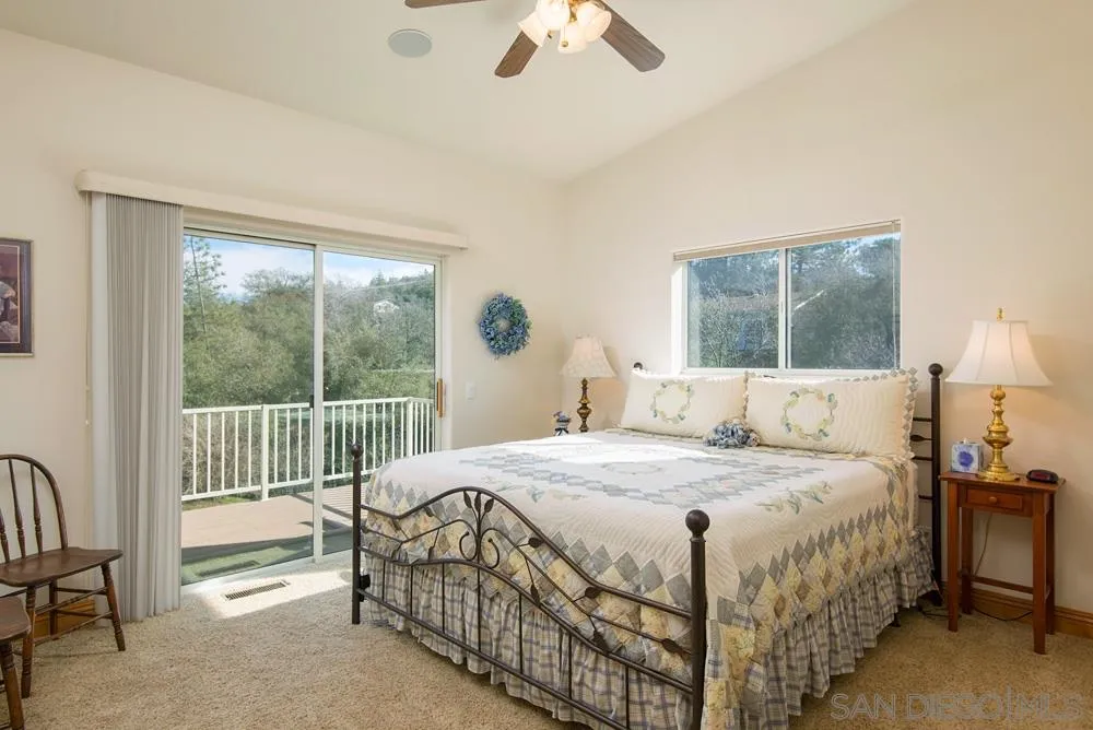 1295 Banner Road Julian, CA 92036 - Photo 13 of 25 a bedroom with a bed and a chandelier