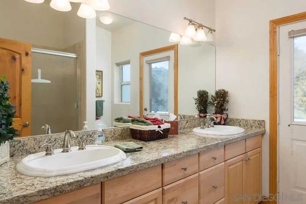 1295 Banner Road Julian, CA 92036 - Photo 14 of 25 a bathroom with double vanity sinks and a mirror