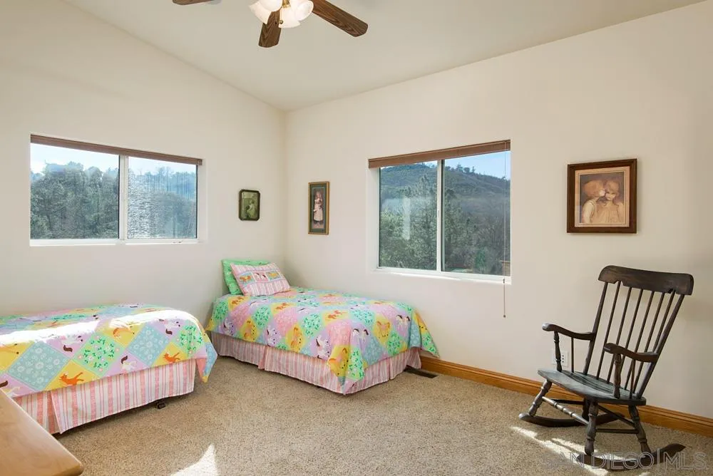 1295 Banner Road Julian, CA 92036 - Photo 16 of 25 a bedroom with a bed and a table