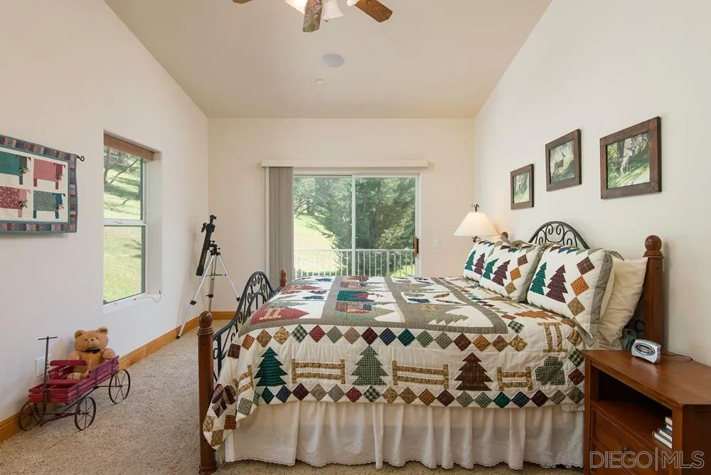 1295 Banner Road Julian, CA 92036 - Photo 17 of 25 a bedroom with a bed and wooden floor