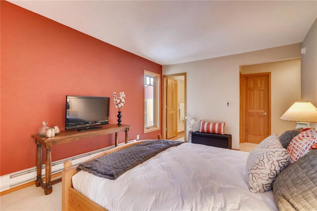 800 Columbine Road, Unit B9 Breckenridge, CO 80424 - Photo 11 of 25 a bedroom with a bed and a flat screen tv