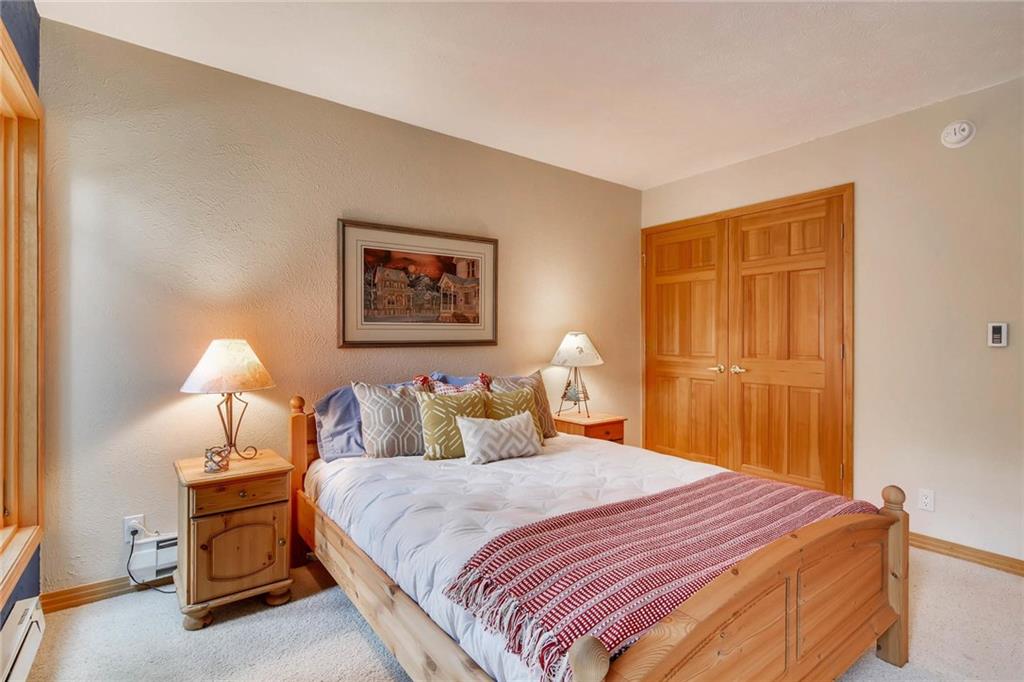 800 Columbine Road, Unit B9 Breckenridge, CO 80424 - Photo 15 of 25 a bedroom with a bed and a painting on the wall