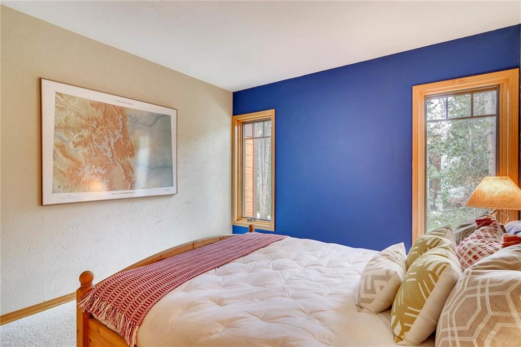 800 Columbine Road, Unit B9 Breckenridge, CO 80424 - Photo 16 of 25 a bedroom with bed and wooden floor