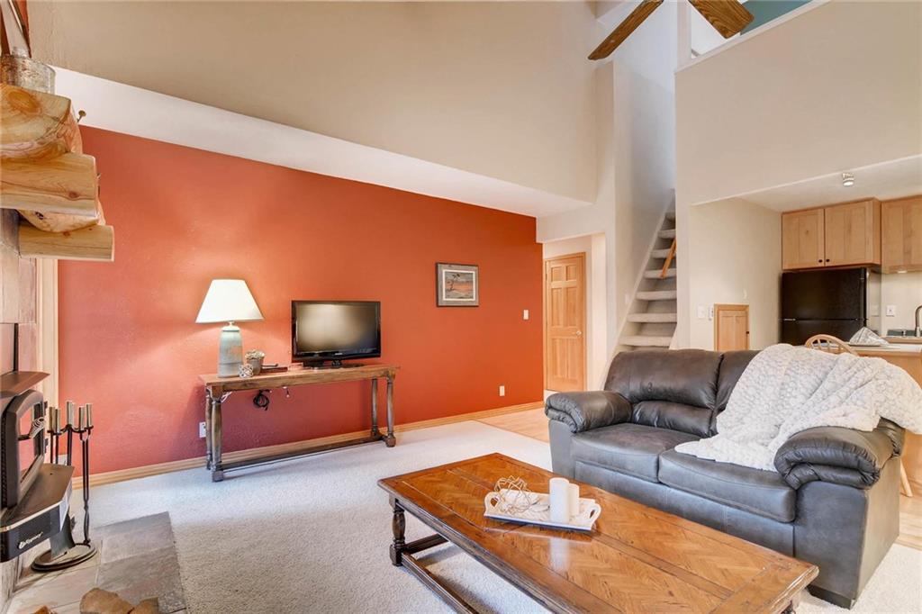 800 Columbine Road, Unit B9 Breckenridge, CO 80424 - Photo 3 of 25 a living room with furniture and a flat screen tv