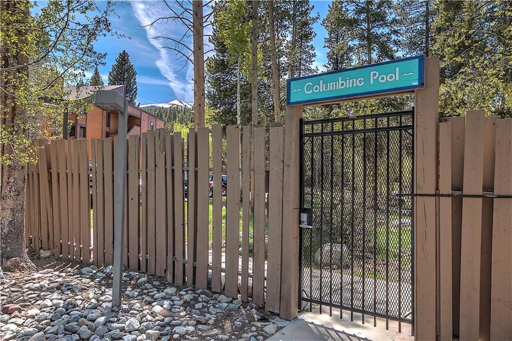 800 Columbine Road, Unit B9 Breckenridge, CO 80424 - Photo 21 of 25 a view of a house with a small yard and wooden fence