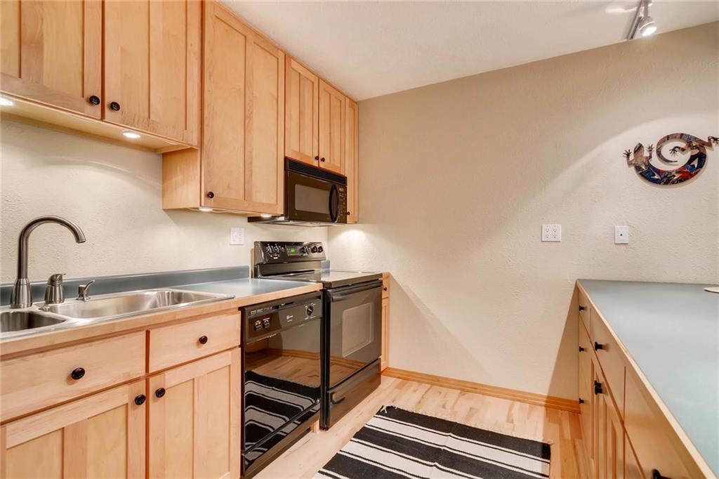 800 Columbine Road, Unit B9 Breckenridge, CO 80424 - Photo 6 of 25 a kitchen with stainless steel appliances cabinets a sink and a stove