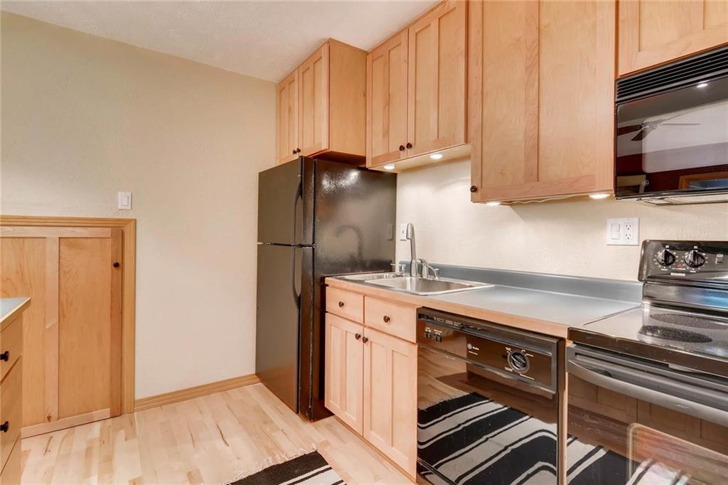 800 Columbine Road, Unit B9 Breckenridge, CO 80424 - Photo 8 of 25 a kitchen with stainless steel appliances granite countertop a refrigerator stove and sink