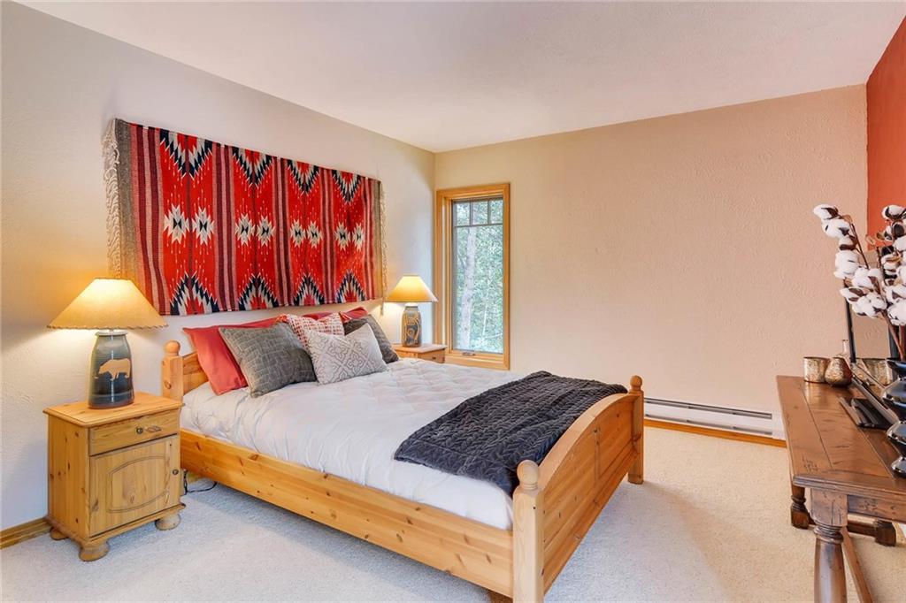 800 Columbine Road, Unit B9 Breckenridge, CO 80424 - Photo 9 of 25 a bedroom with a bed and a lamp with window