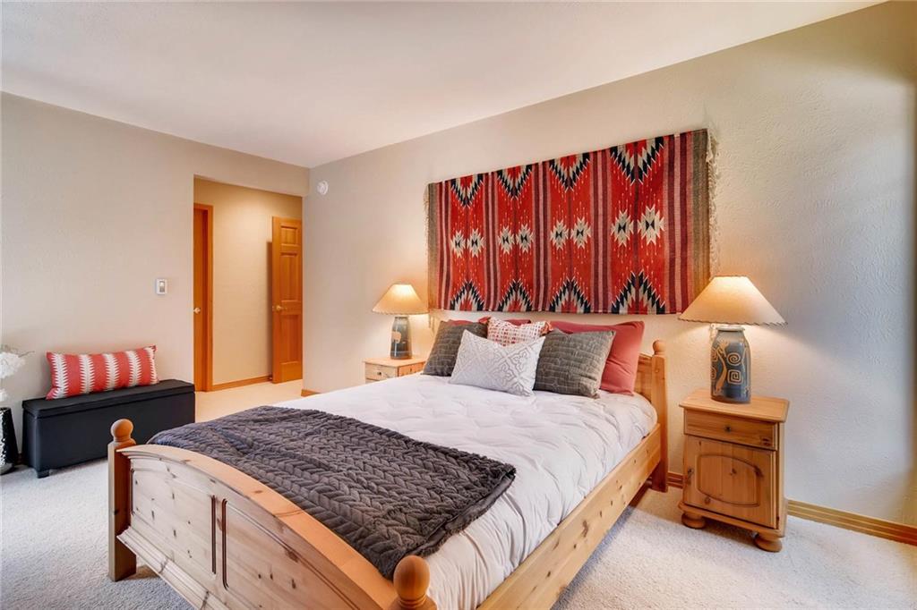 800 Columbine Road, Unit B9 Breckenridge, CO 80424 - Photo 10 of 25 a bedroom with a bed and a lamp with the dresser