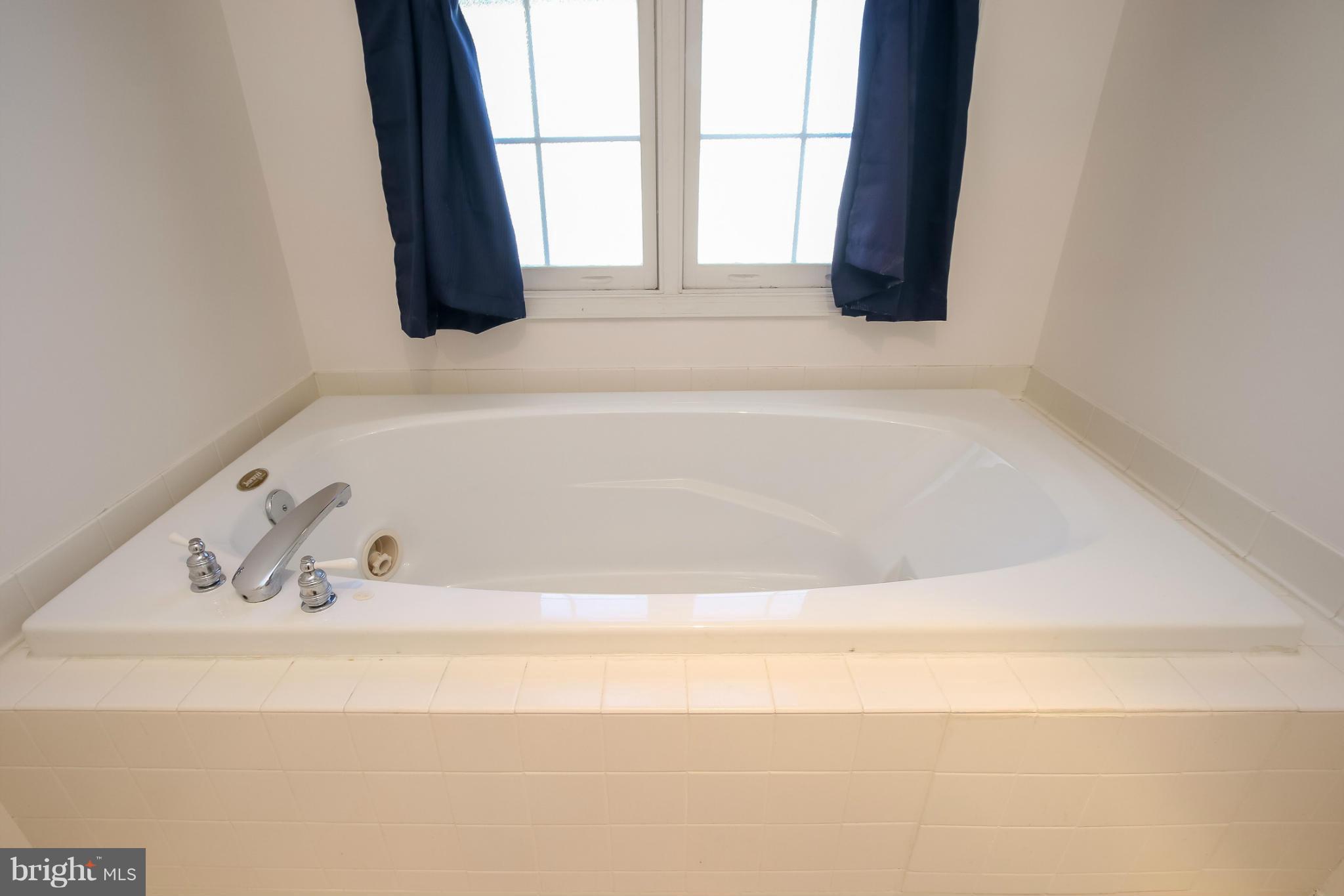 2446 Five Shillings Road Frederick, MD 21701 - Photo 21 of 30 a white bath tub sitting next to a window