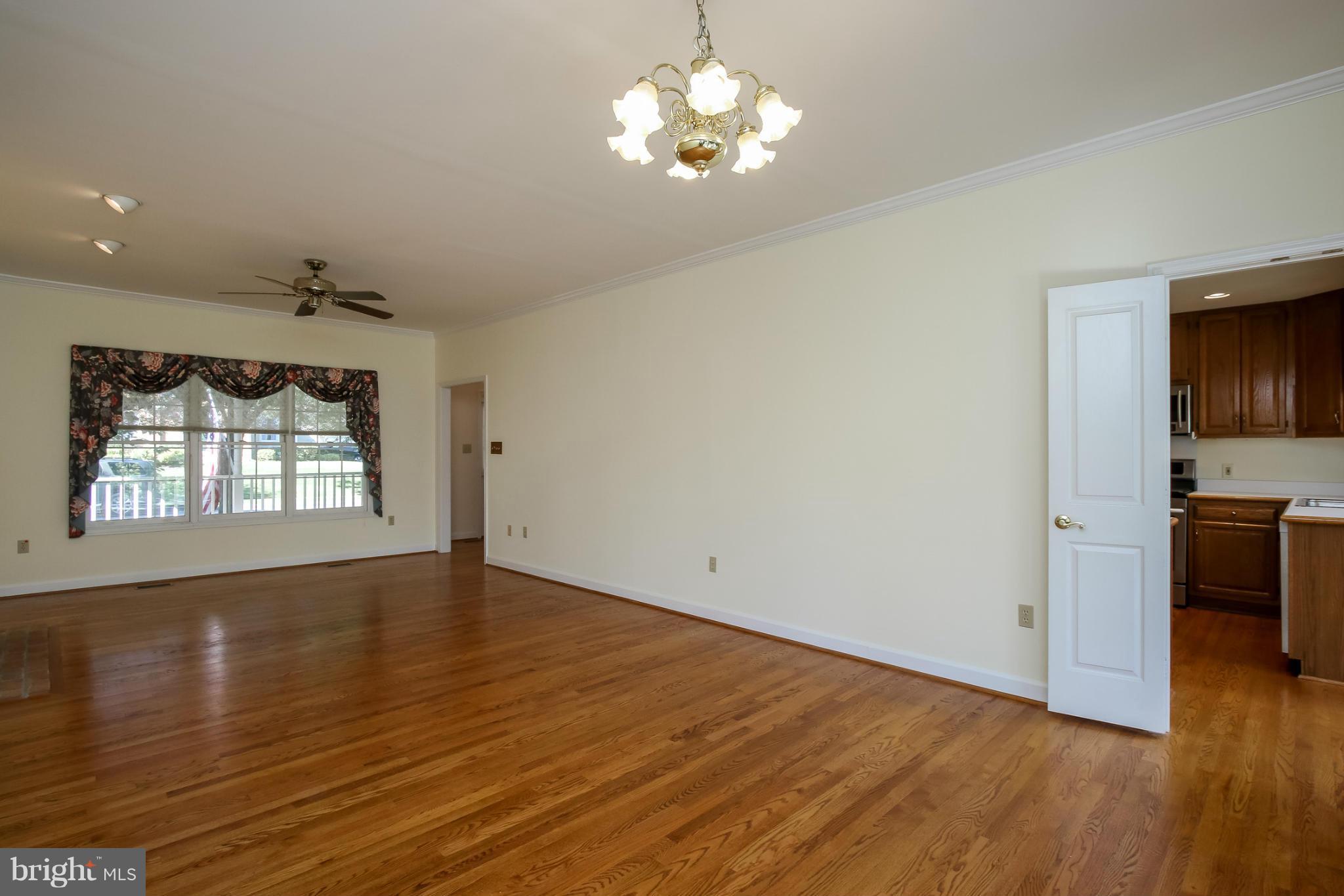 2446 Five Shillings Road Frederick, MD 21701 - Photo 7 of 30 a view of an empty room with a window and wooden floor