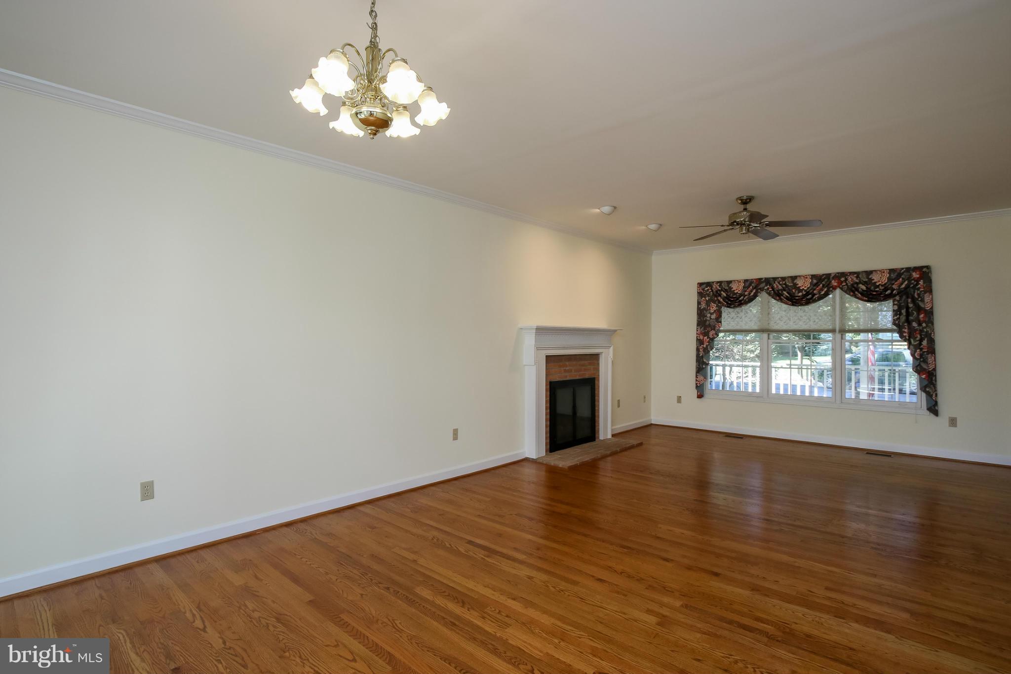 2446 Five Shillings Road Frederick, MD 21701 - Photo 9 of 30 a view of an empty room with a window and wooden floor