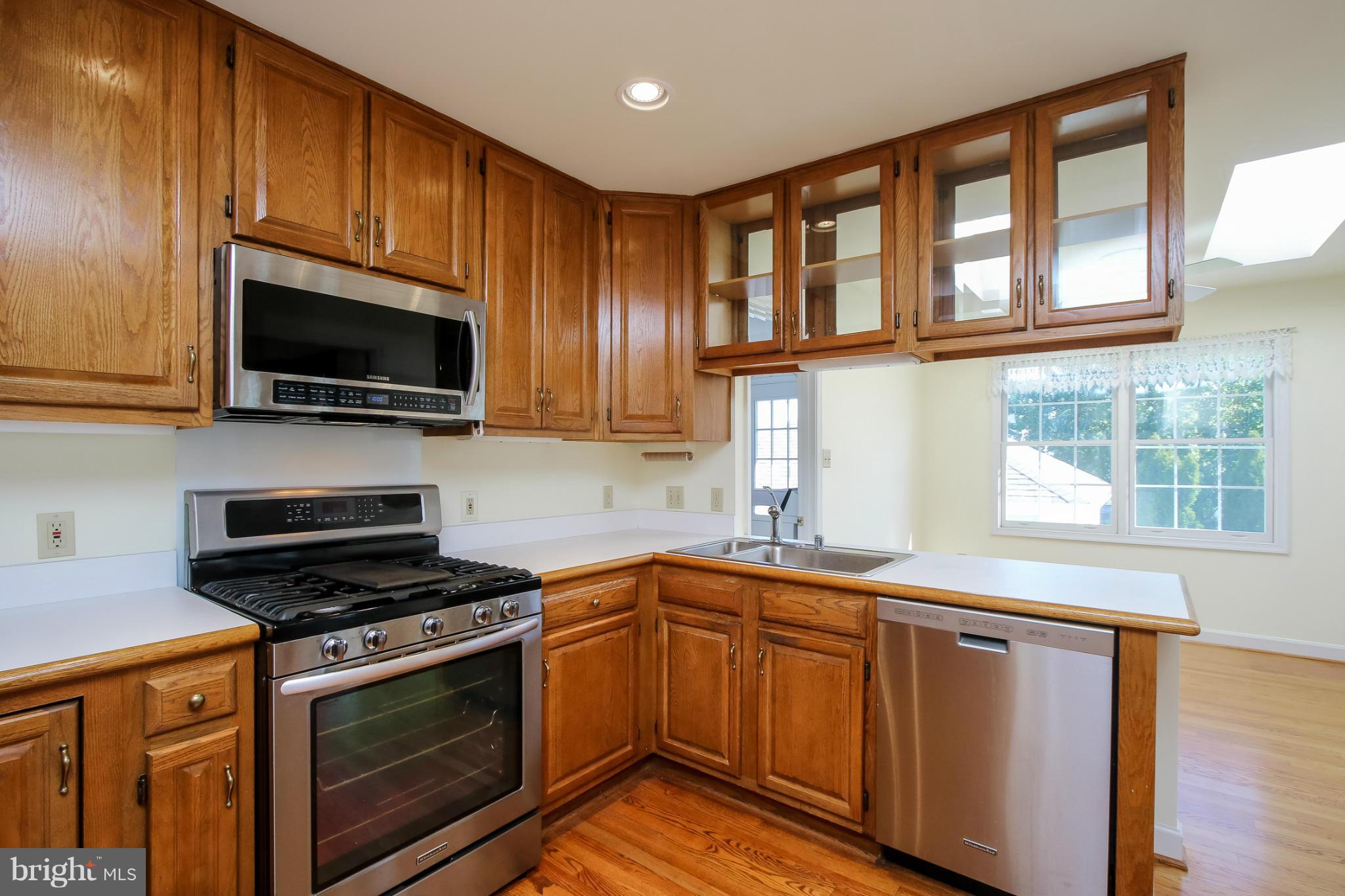 2446 Five Shillings Road Frederick, MD 21701 - Photo 10 of 30 a kitchen with stainless steel appliances a stove sink microwave and cabinets