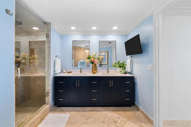 a bathroom with a granite countertop sink mirror vanity and toilet
