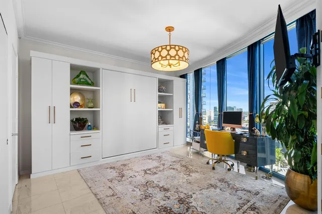 a bedroom with furniture and a potted plant
