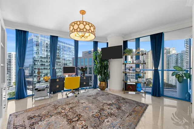 a view of a hallway with wooden floor and a potted plant