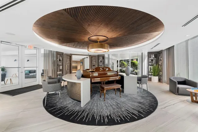 a view of a living room and kitchen with a chandelier