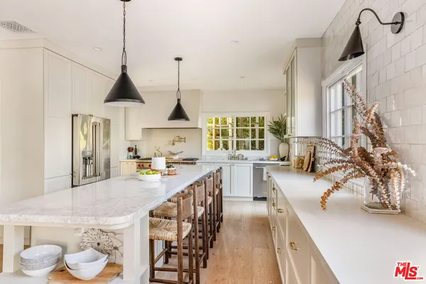 a kitchen with stove and cabinets
