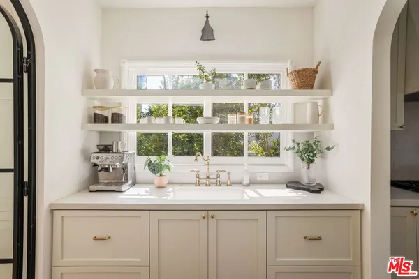 a bathroom with a sink and a large mirror