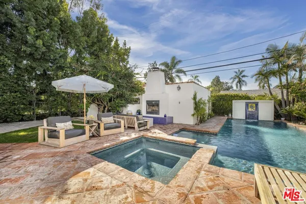 a view of a house with backyard and sitting area