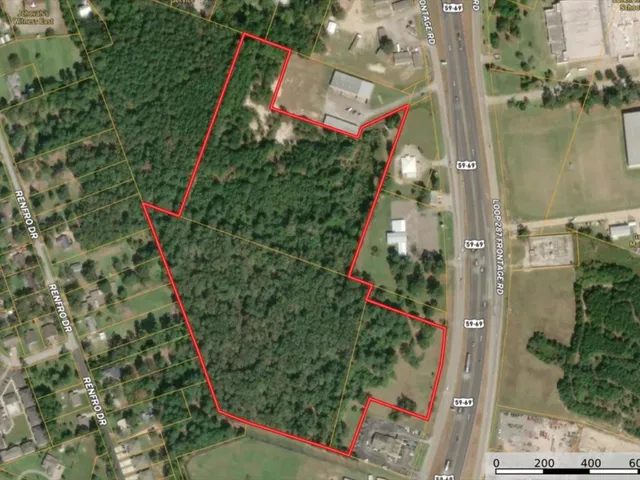 an aerial view of a houses with street