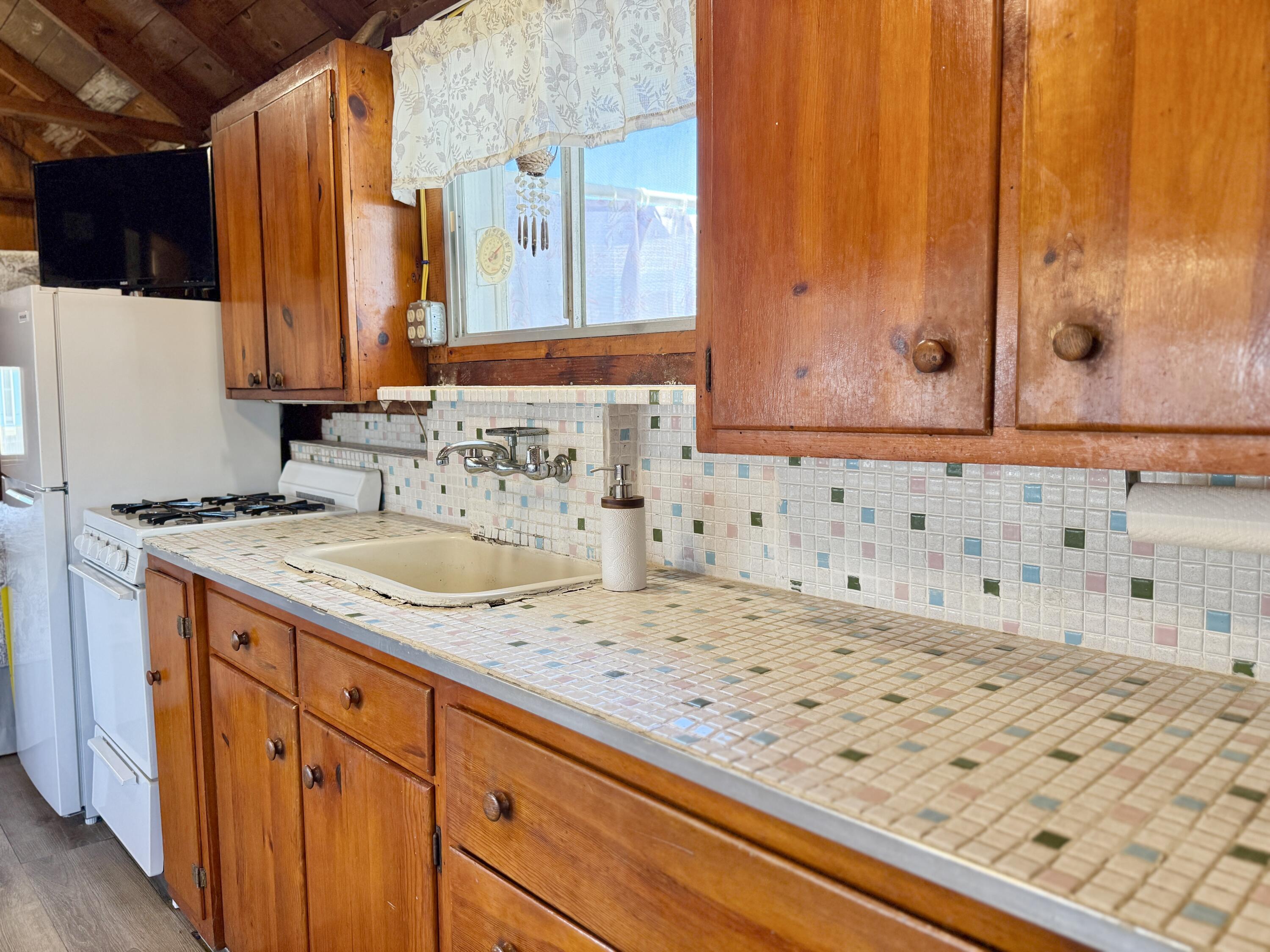 217 Old Wharf Road, Unit 64 Dennis Port, MA 02639 - Photo 19 of 25 a bathroom with a granite countertop sink and a mirror