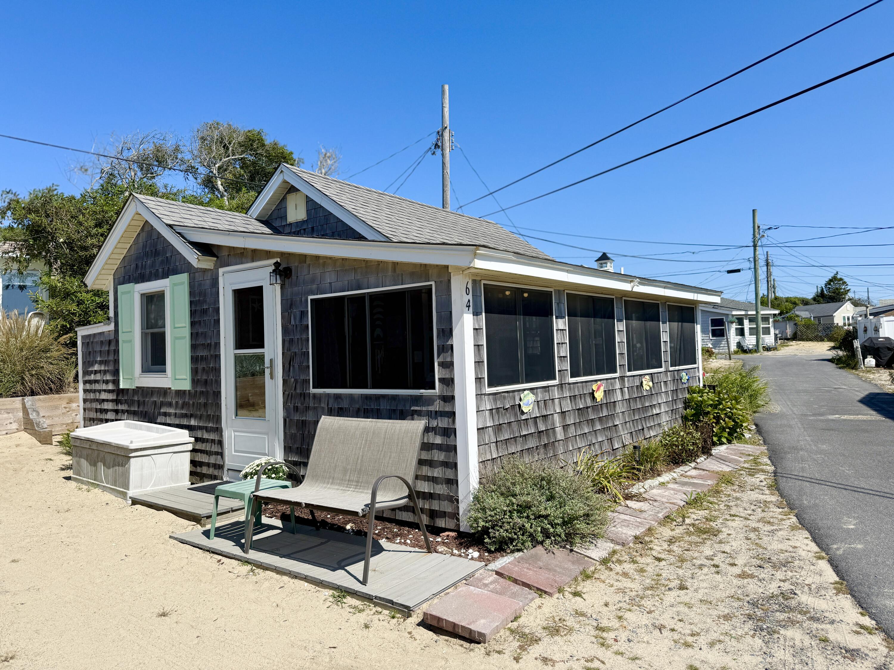 217 Old Wharf Road, Unit 64 Dennis Port, MA 02639 - Photo 2 of 25 a view of a house with backyard sitting area and porch