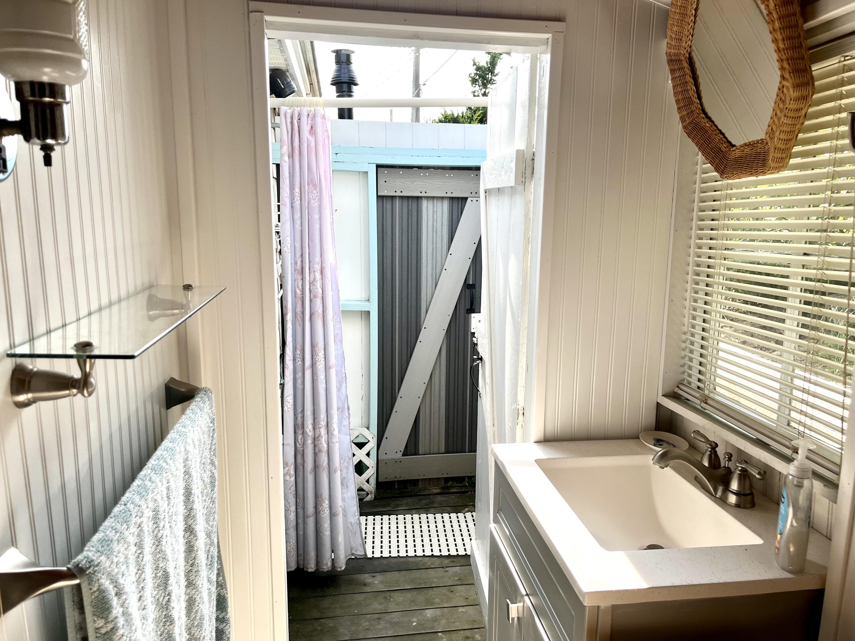 217 Old Wharf Road, Unit 64 Dennis Port, MA 02639 - Photo 21 of 25 a bathroom with a sink a mirror and a window