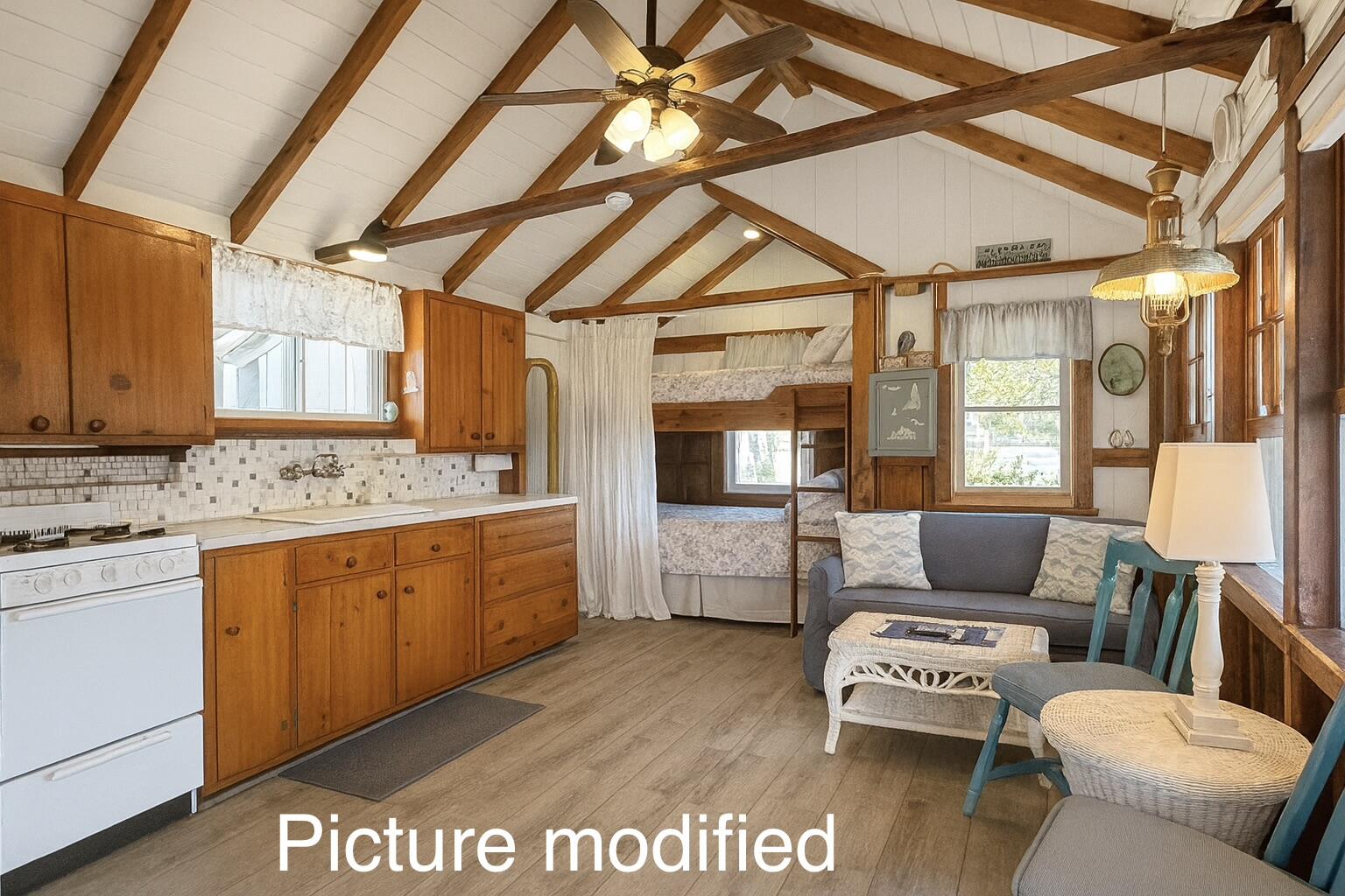 217 Old Wharf Road, Unit 64 Dennis Port, MA 02639 - Photo 25 of 25 a spacious bedroom with a bed a couch and dresser