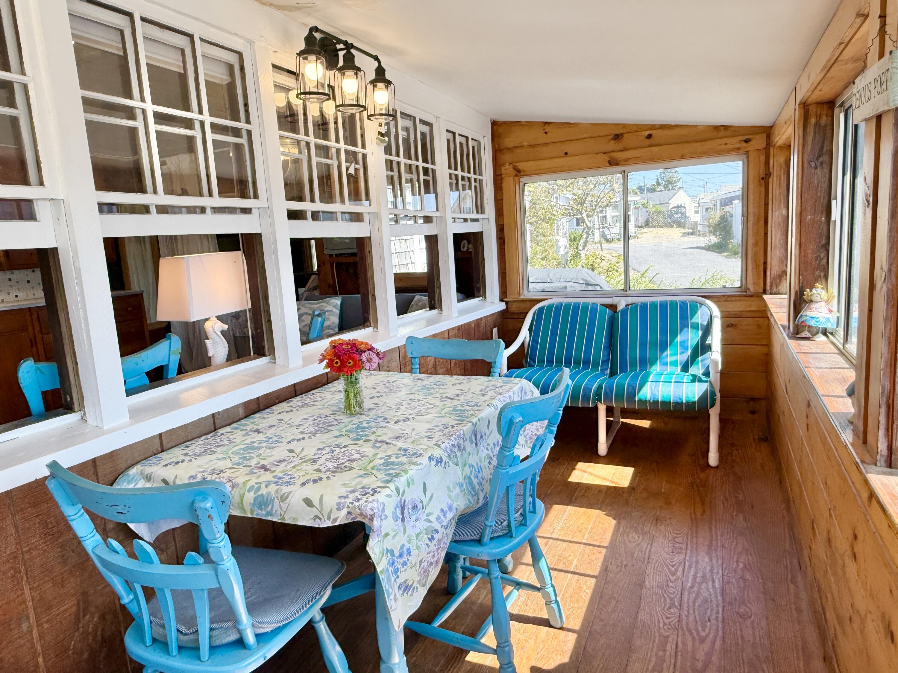 217 Old Wharf Road, Unit 64 Dennis Port, MA 02639 - Photo 8 of 25 a view of a dining room with furniture window and wooden floor