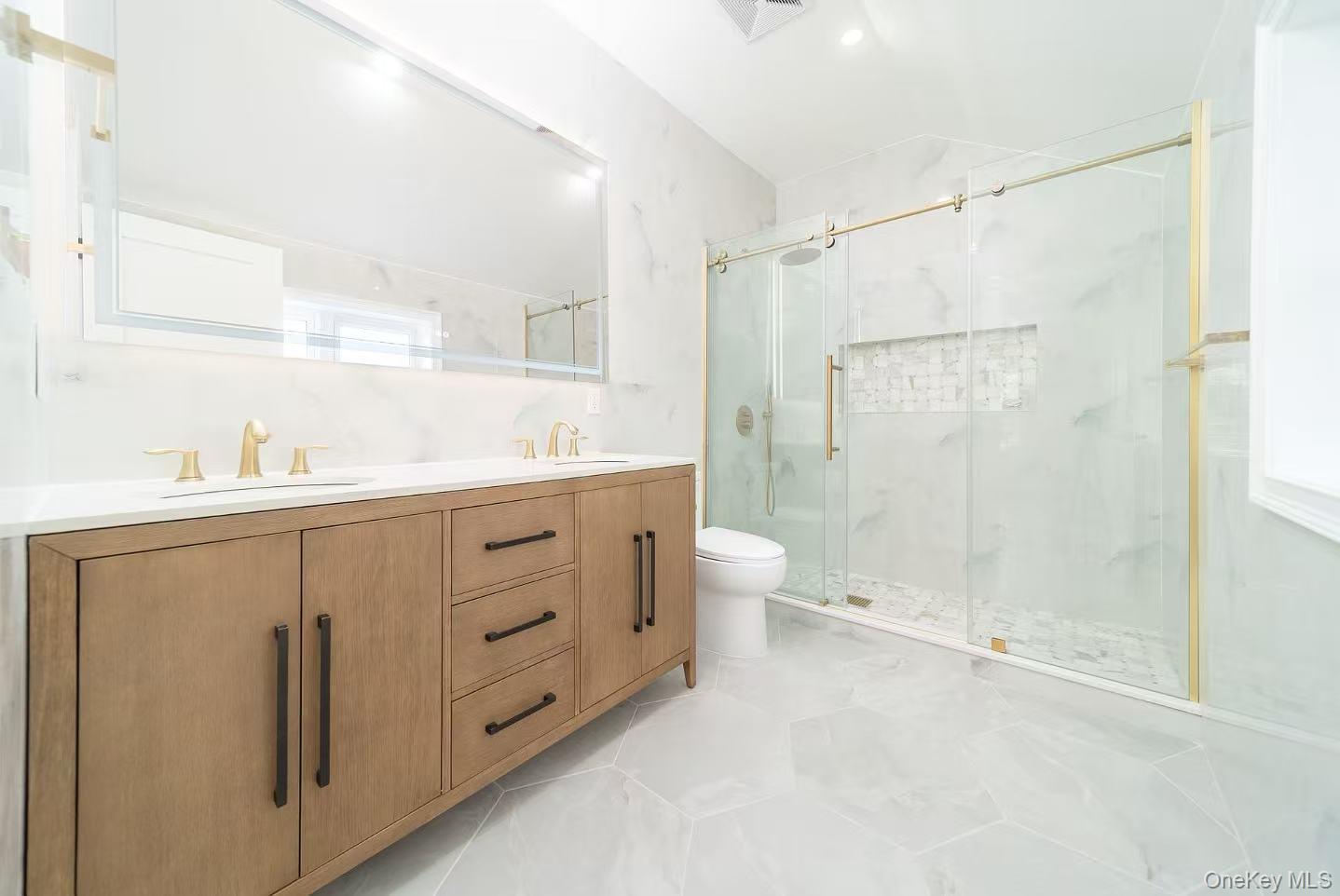 7-24 128th Street Queens, NY 11356 - Photo 10 of 31 Bathroom with a marble finish shower, double vanity, light tile patterned floors, and lofted ceiling